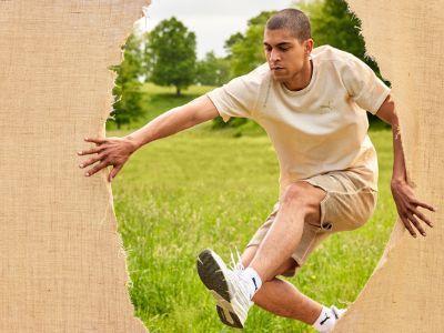 man jumping through a canvas