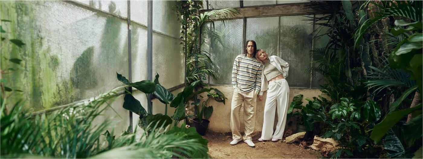 two people standing in a greenhouse