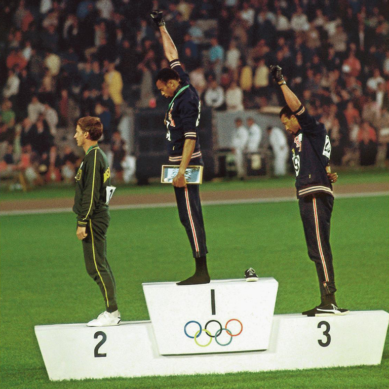 Tommie Smith raising his hand